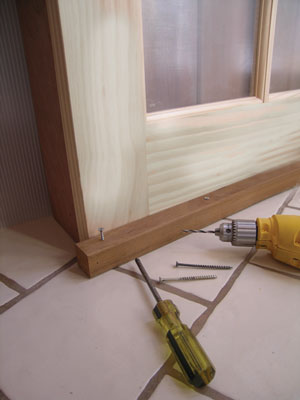 A wooden guide keeps the door on track.